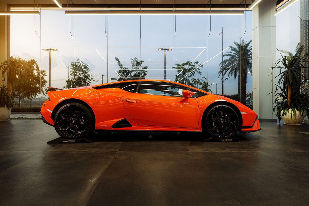 High-gloss dark floor reflecting a car in a showroom